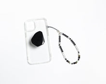 Load image into Gallery viewer, WMC Leo Zodiac phone charm displayed on a clear phone case with Obsidian phone grip

