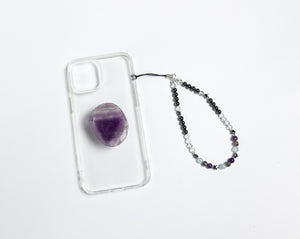 WMC Pisces Zodiac phone charm displayed on a clear phone case with Amethyst phone grip
